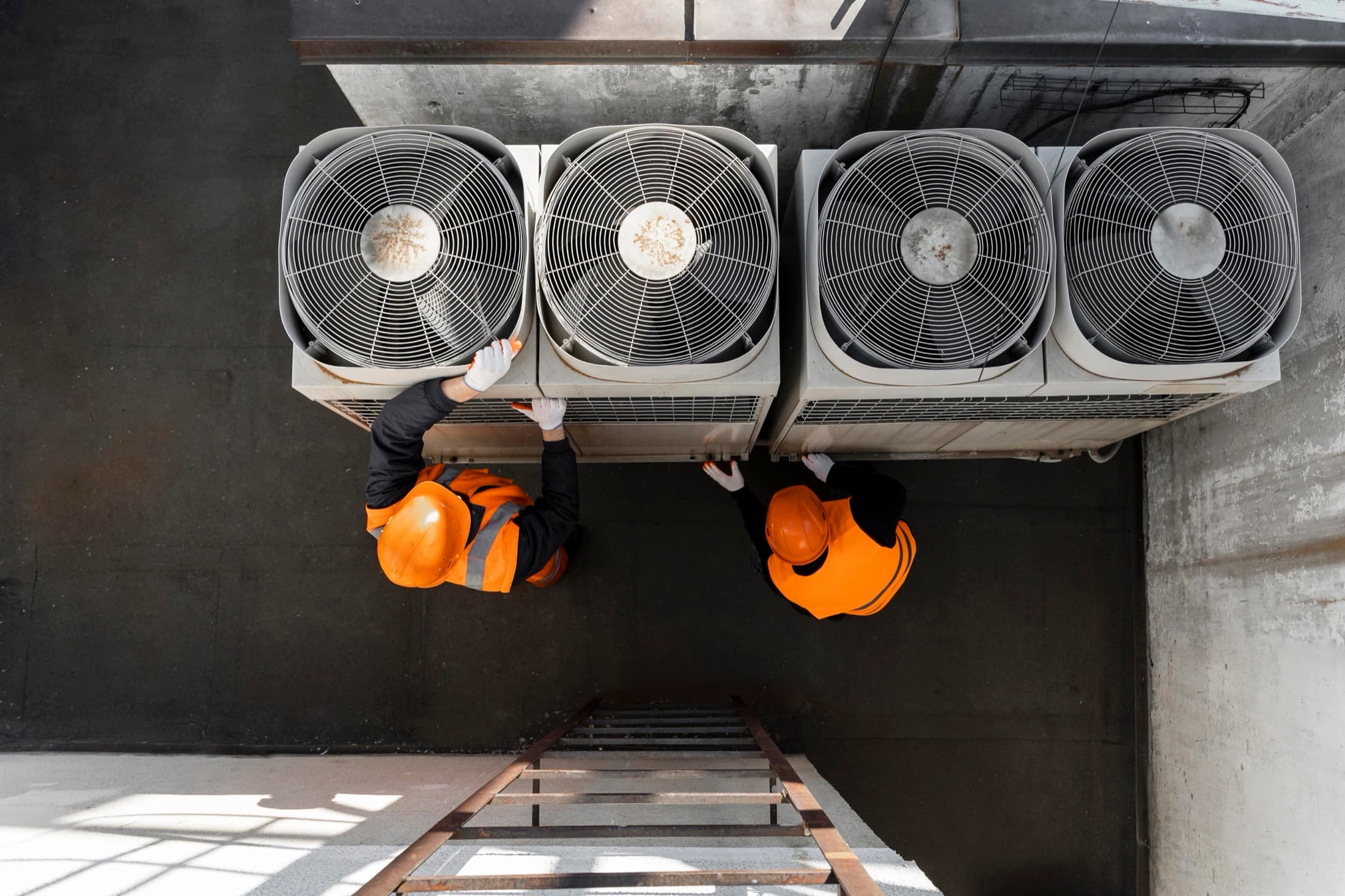 HVAC technicians working together on new equipment installation